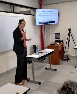 A person standing in front of a whiteboard

Description automatically generated